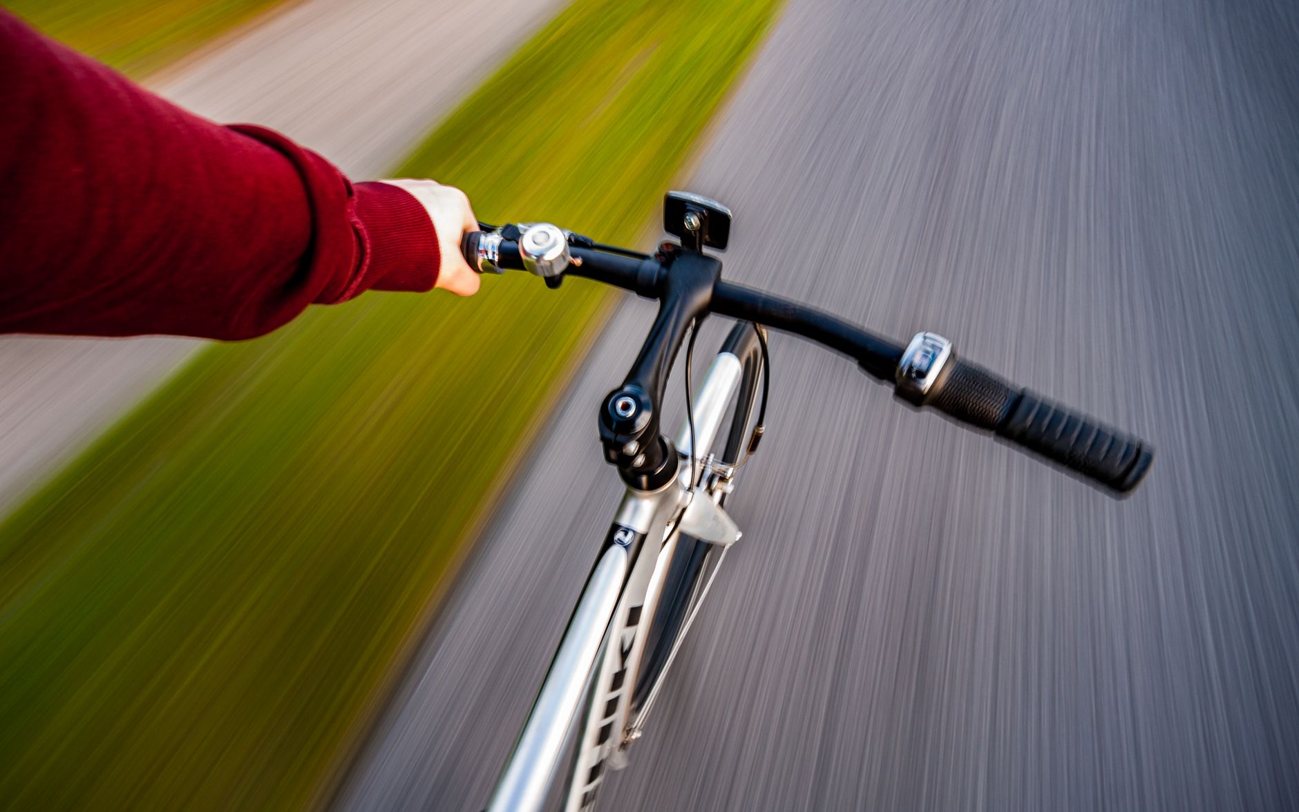 person in red sweater riding on bicycle