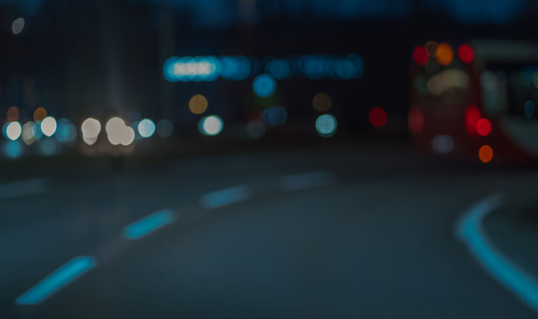 defocused photo of a street and cars in city