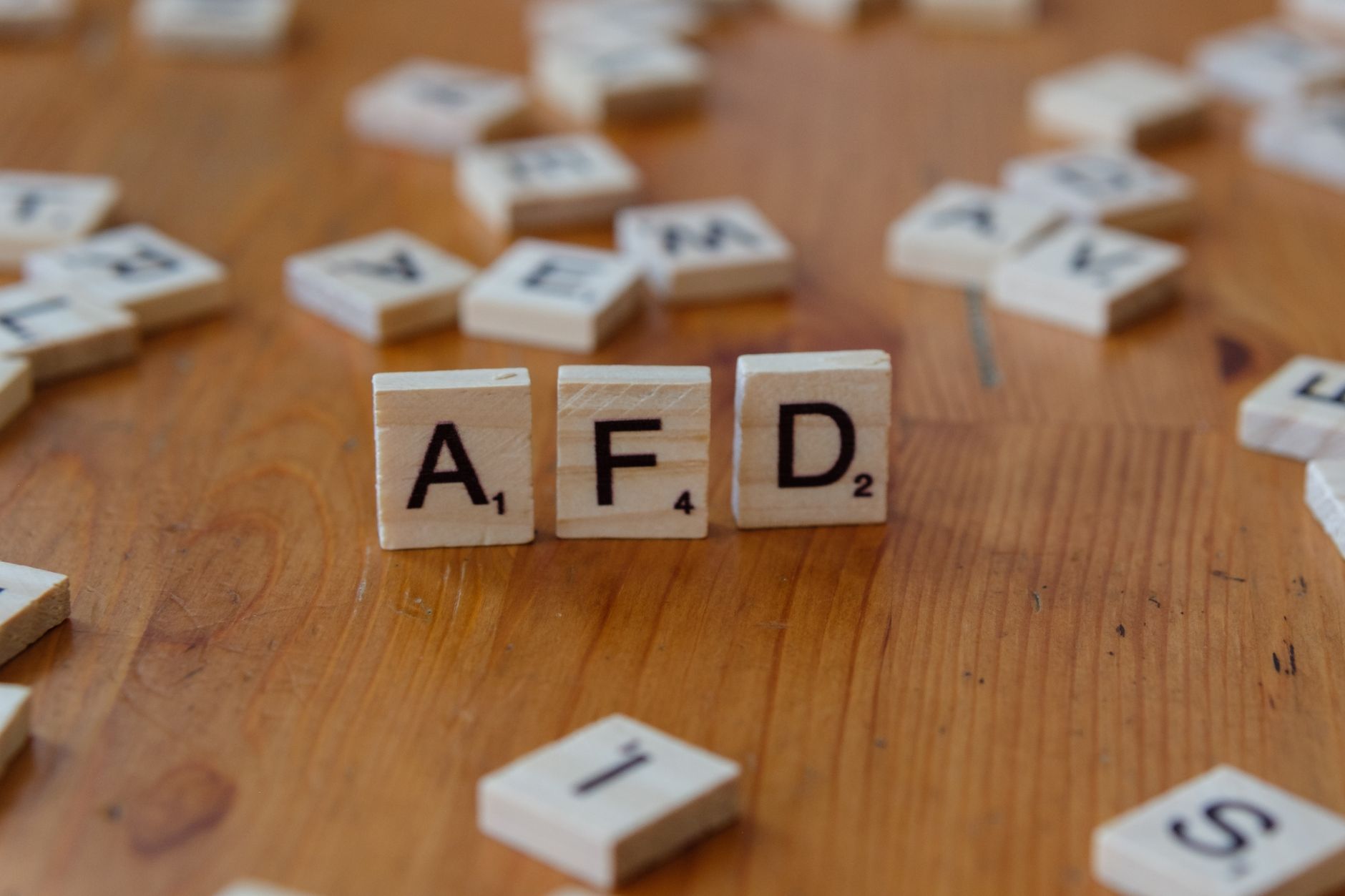 scrabble tiles spelling afd on wooden table