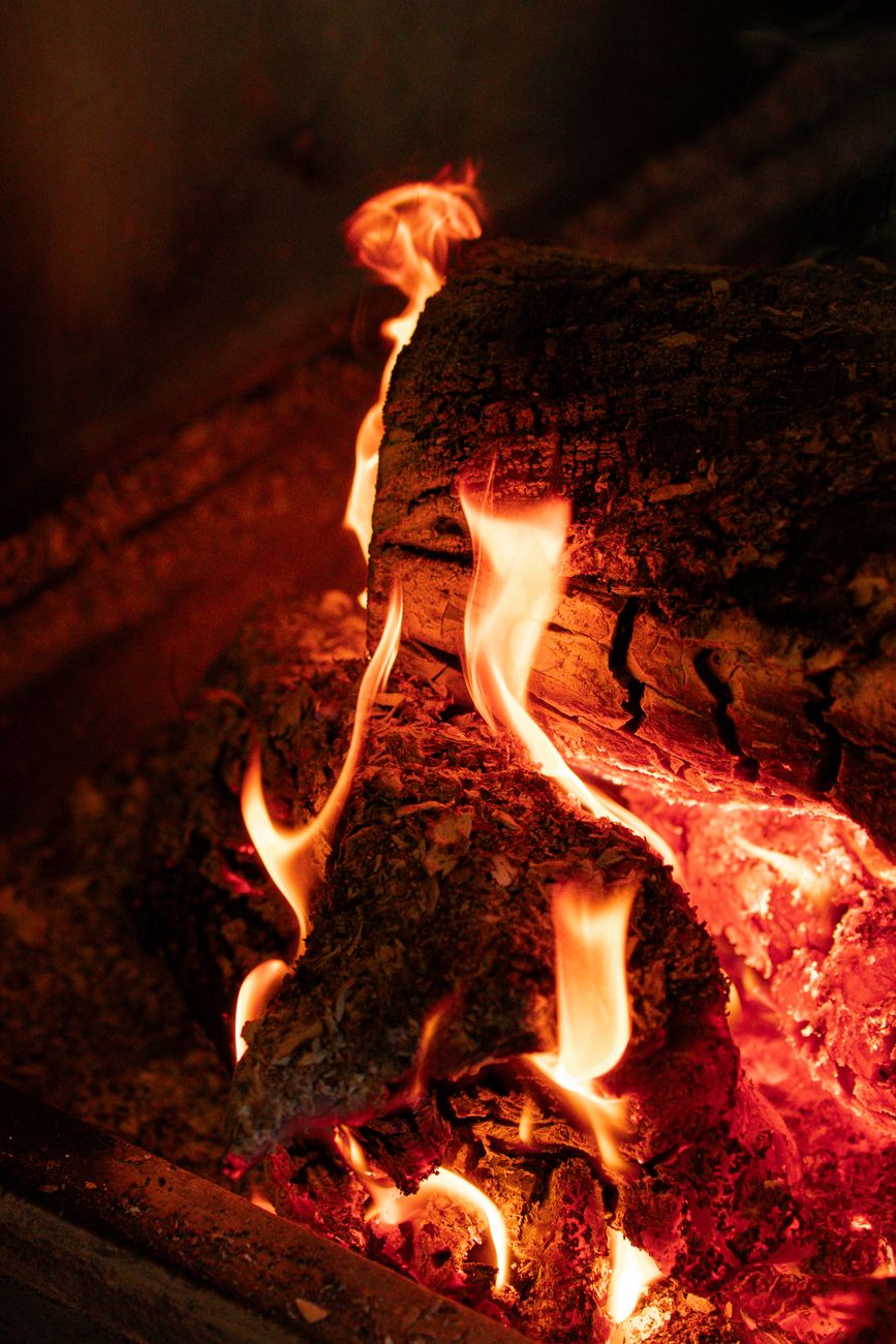 close up of glowing firewood in fireplace
