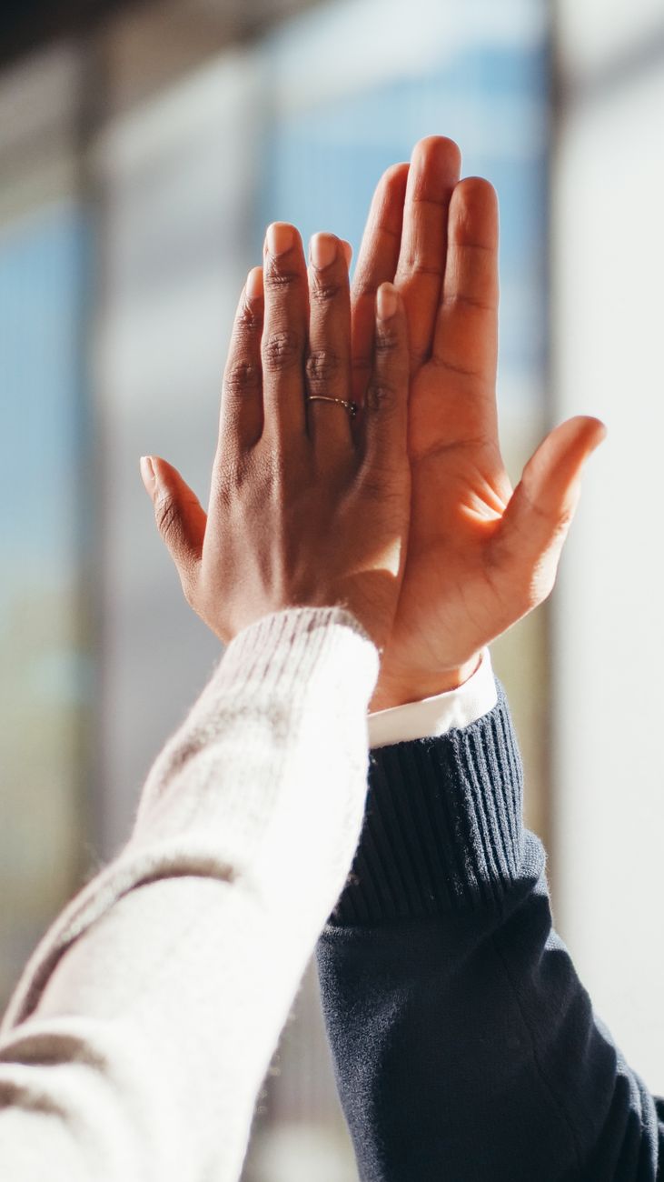 close up photo of people doing high five