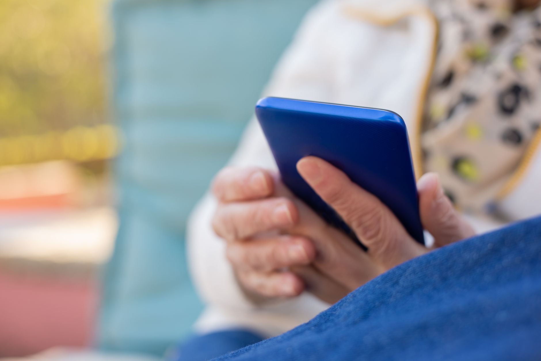 a person holding a blue cellphone