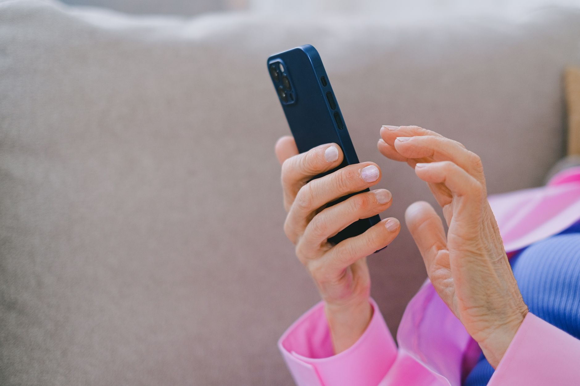 a person s hands using a cell phone