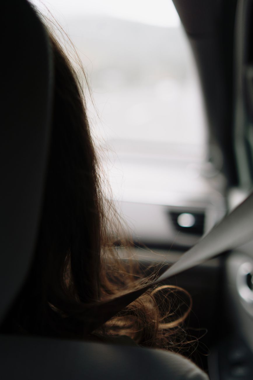 backseat view of passenger in car interior