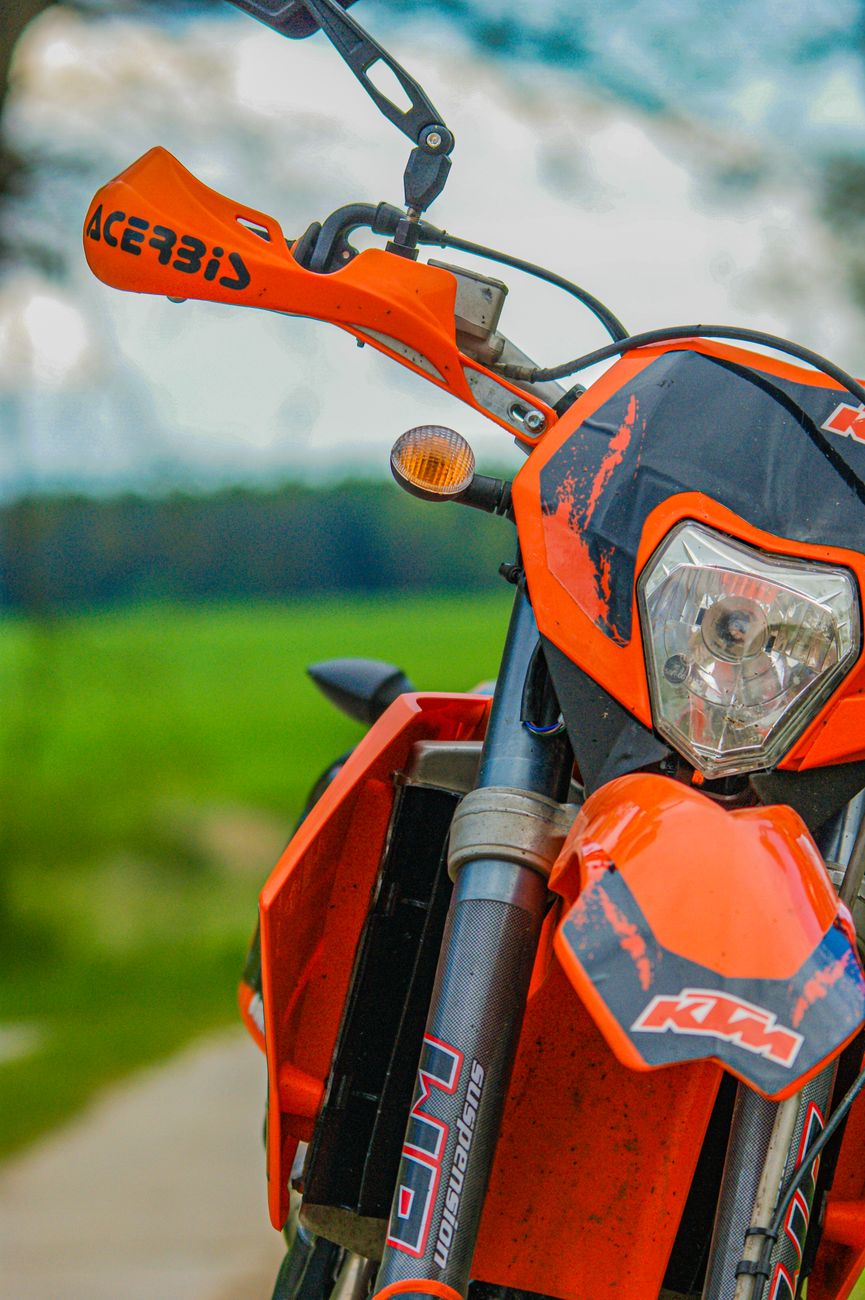 close up of a vibrant orange motorbike outdoors