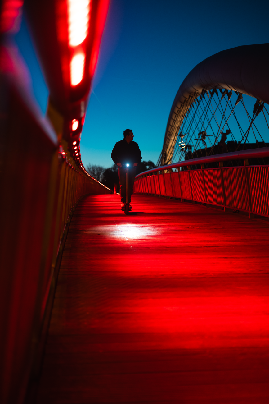 futuristic urban night ride on illuminated bridge