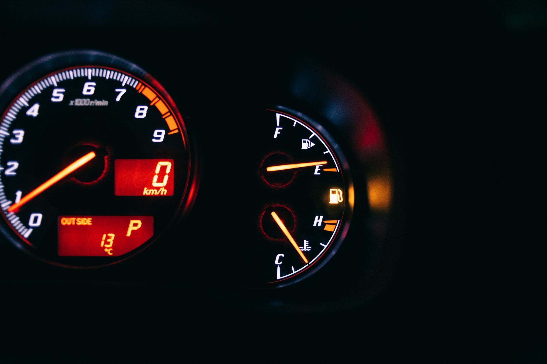 car dashboard with tachometer and fuel gauge