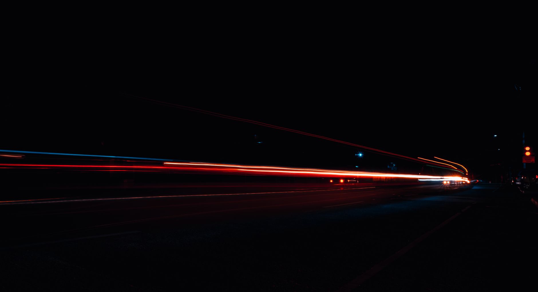 multi colored light streaks on black background