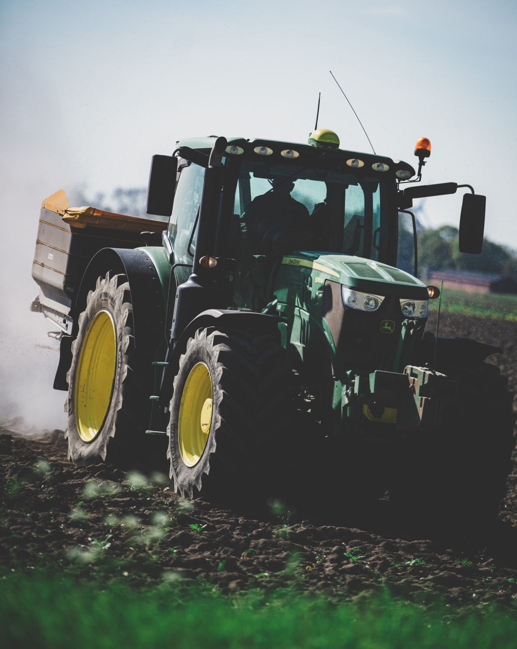 tractor driving through muddy field